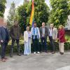 foto schepencollege tijdens uithangen van regenboogvlag bij GC Sint-Jozef